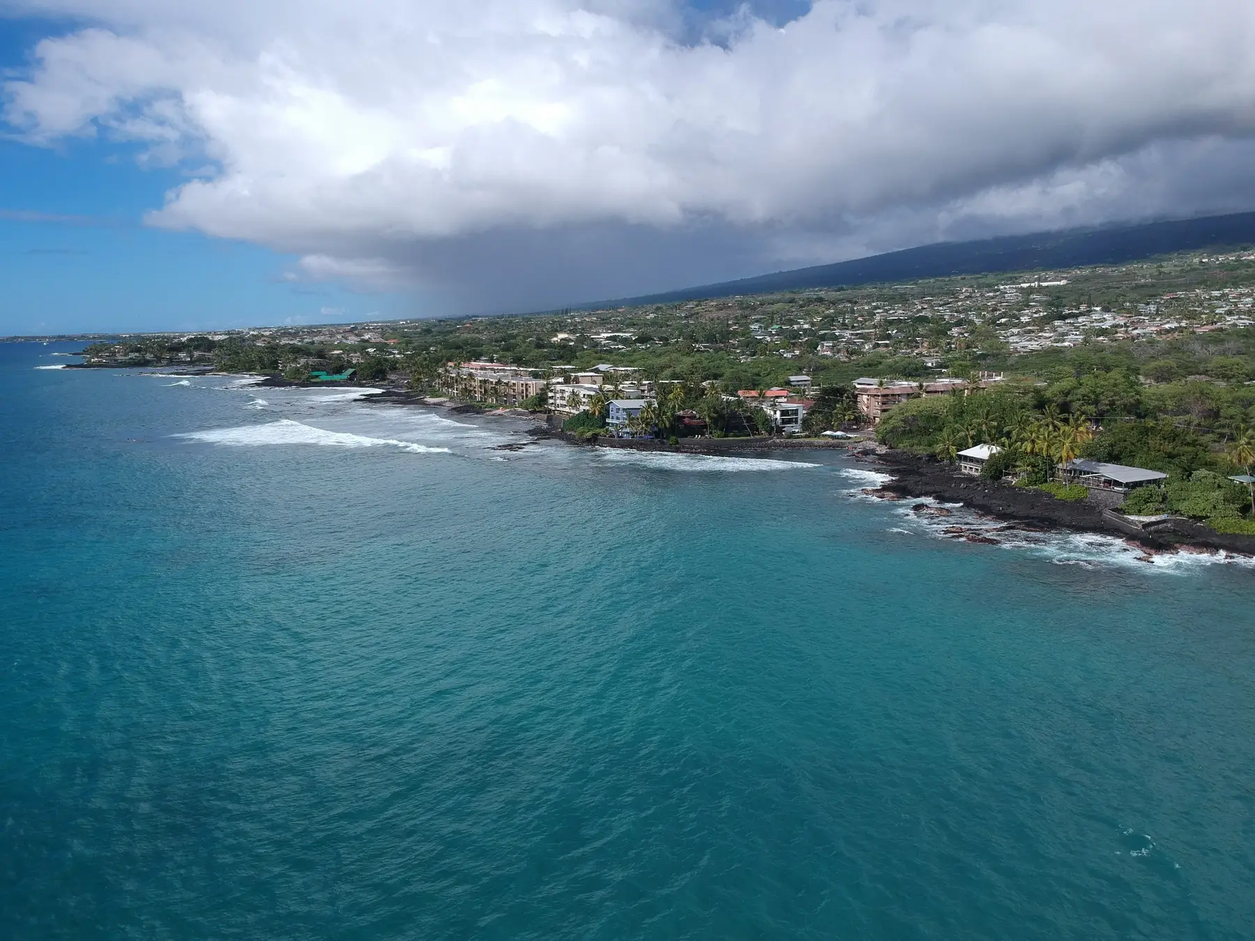 Aerial view of coastal Kona homes and ocean